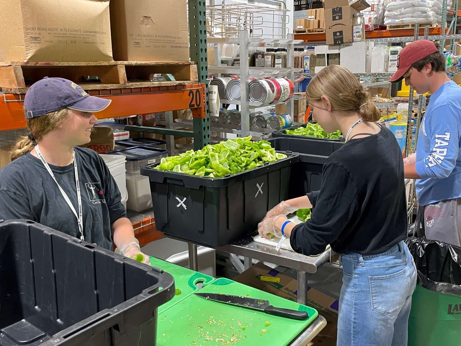 Students from Notre Dame preparing and chopping lettuce